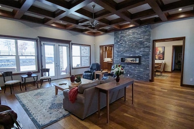 living room featuring a fireplace, coffered ceiling, french doors, ceiling fan, and dark hardwood / wood-style floors