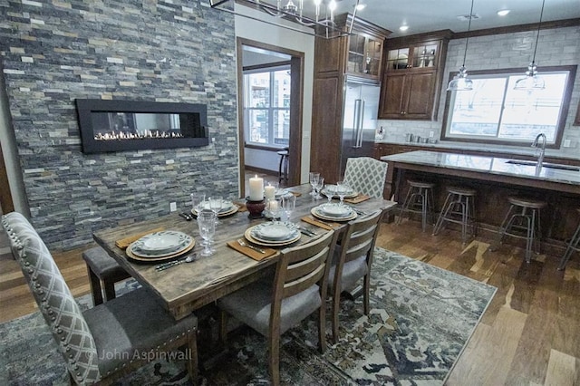 dining room with sink and dark hardwood / wood-style floors