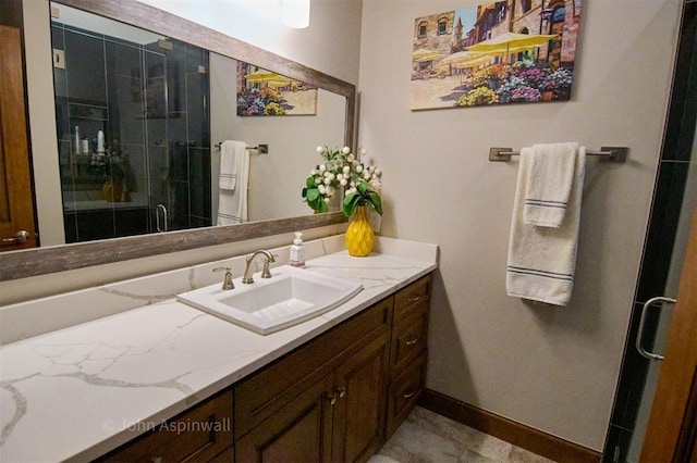 bathroom featuring an enclosed shower and vanity