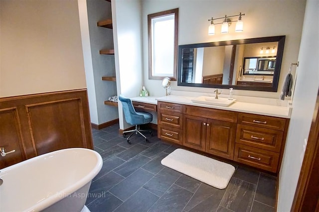 bathroom featuring a tub to relax in, built in shelves, and vanity