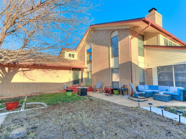 back of property featuring a patio area and outdoor lounge area