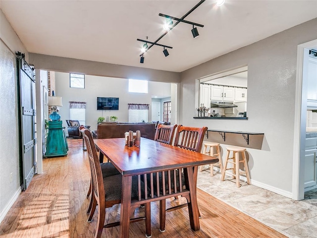 dining area featuring plenty of natural light and light hardwood / wood-style floors