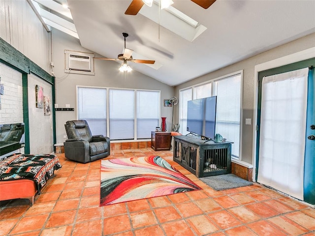 living room with a wall unit AC, ceiling fan, and lofted ceiling with skylight