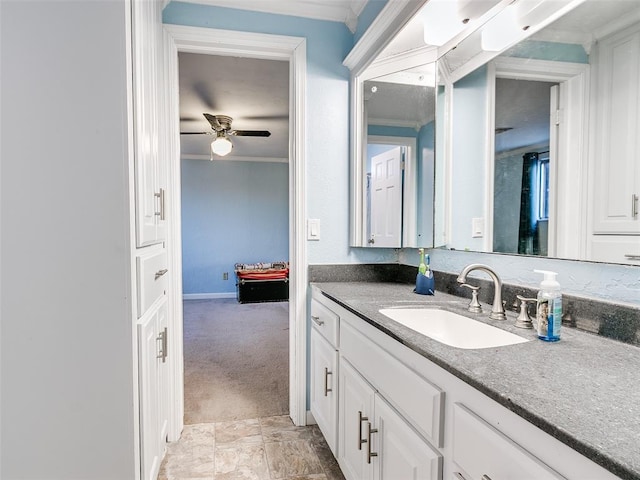 bathroom with ceiling fan, ornamental molding, and vanity