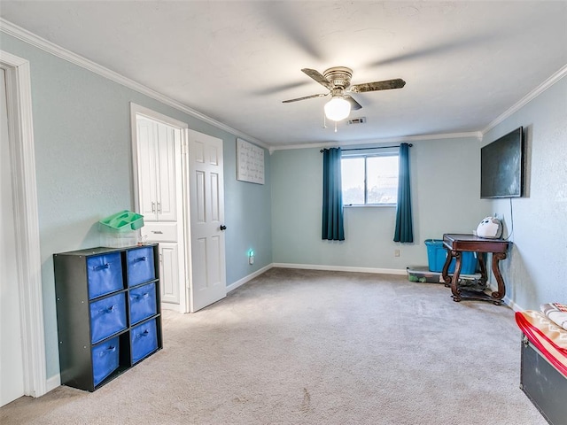 misc room featuring ceiling fan, crown molding, and light carpet