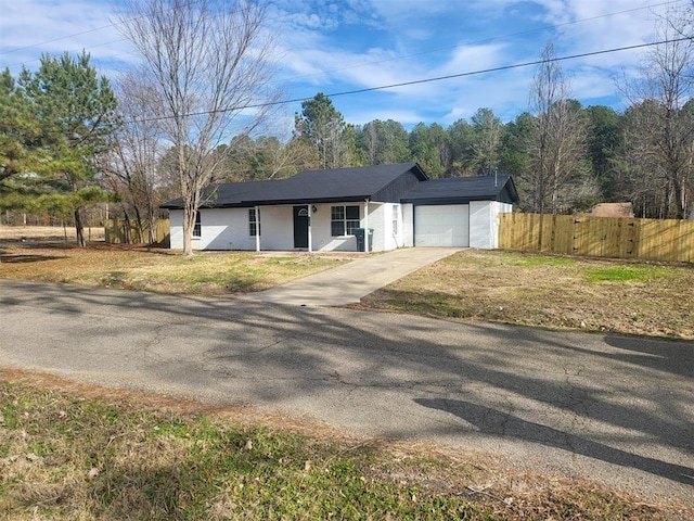 ranch-style house featuring a garage and a front yard