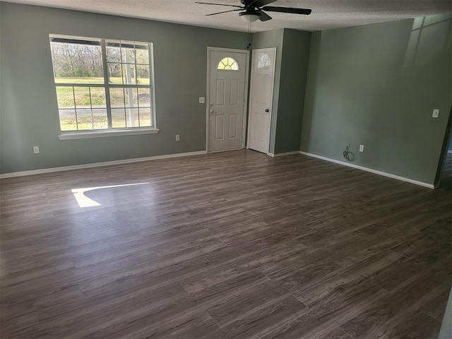 foyer featuring a textured ceiling, dark wood-type flooring, and ceiling fan