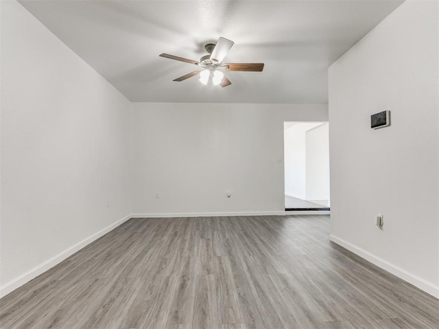 empty room featuring ceiling fan and wood-type flooring