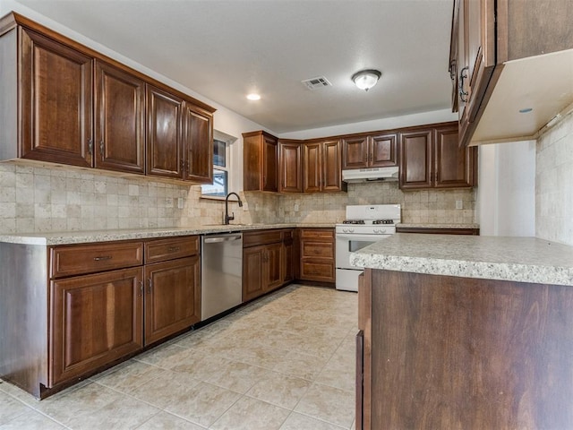 kitchen featuring stainless steel dishwasher, gas range gas stove, decorative backsplash, sink, and light tile patterned flooring