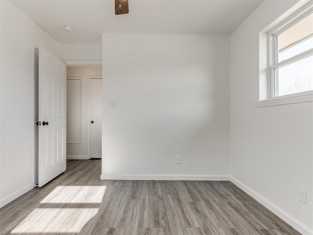 spare room featuring ceiling fan and light wood-type flooring