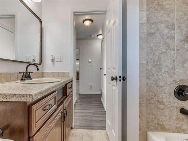 bathroom featuring walk in shower and vanity