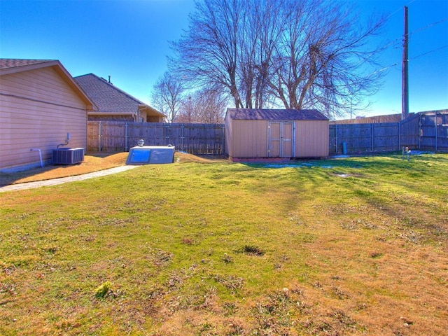 view of yard featuring central AC unit and a storage unit