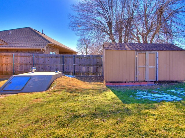 view of storm shelter with a shed and a lawn