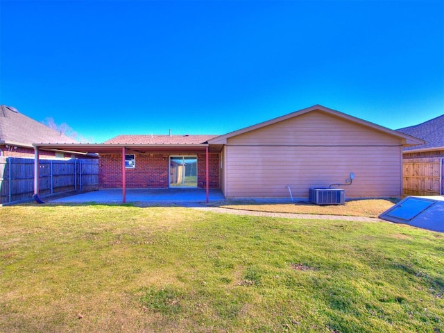 rear view of house with a patio area and a lawn