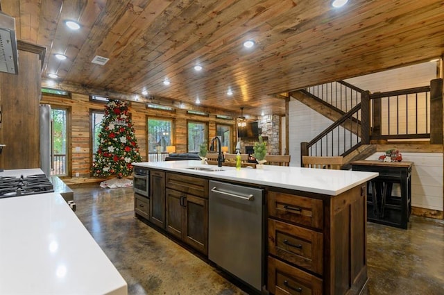 kitchen with stainless steel dishwasher, sink, wood ceiling, and a kitchen island with sink