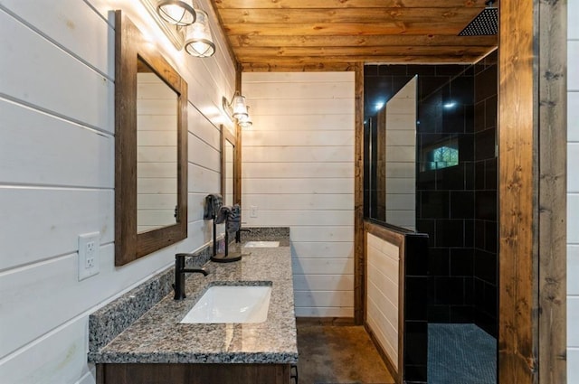 bathroom with tiled shower, wood walls, wood ceiling, and vanity