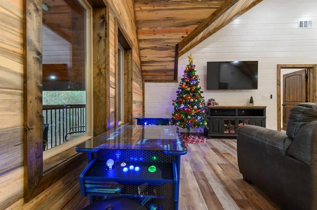 interior space with hardwood / wood-style flooring, beamed ceiling, wood walls, and wood ceiling