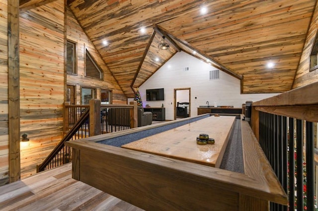 recreation room with hardwood / wood-style flooring, wooden walls, lofted ceiling, and wood ceiling