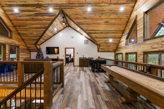 rec room featuring wood walls, high vaulted ceiling, wood ceiling, and wood-type flooring