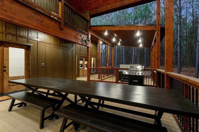 dining room with wood walls and light hardwood / wood-style floors