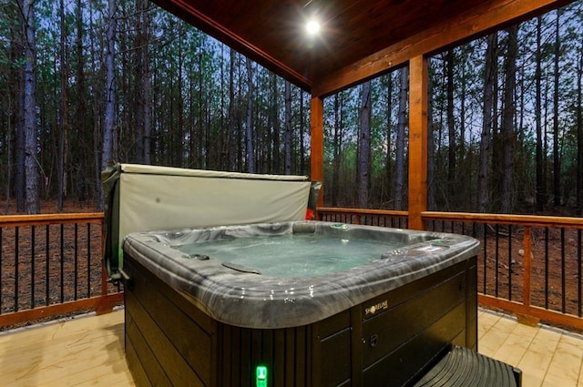 wooden deck featuring a hot tub