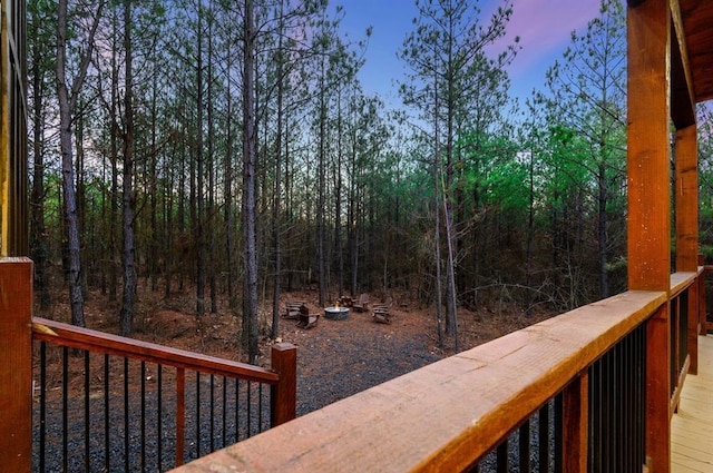 deck at dusk featuring a fire pit