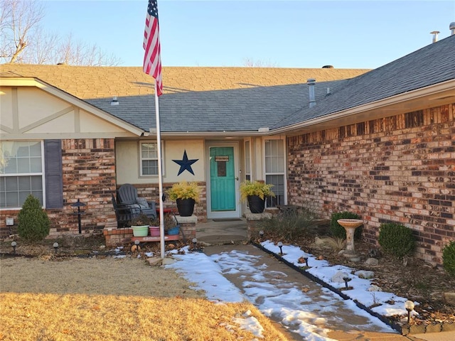 view of snow covered property entrance