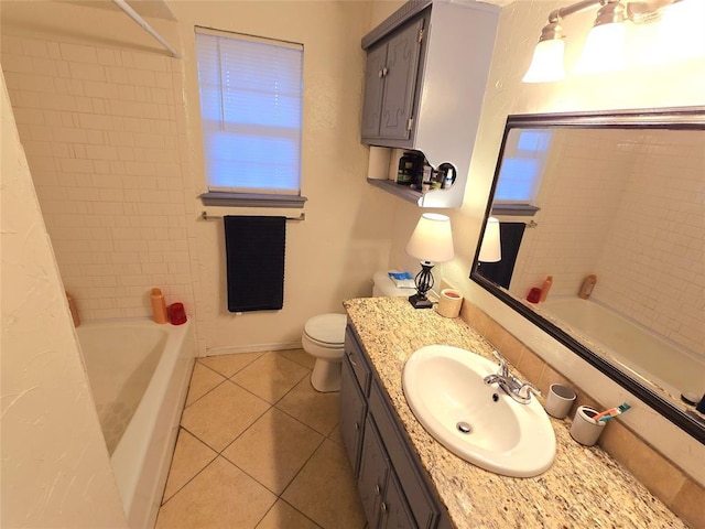 full bathroom with tile patterned flooring, vanity, tiled shower / bath combo, and toilet