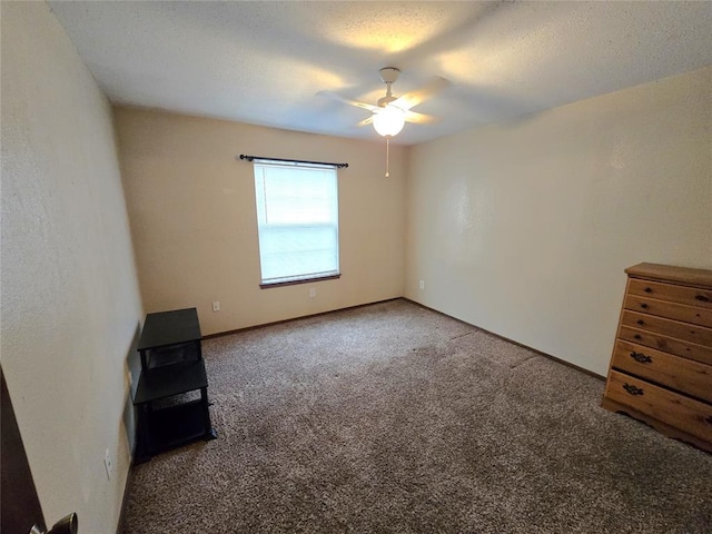 interior space with ceiling fan and a textured ceiling