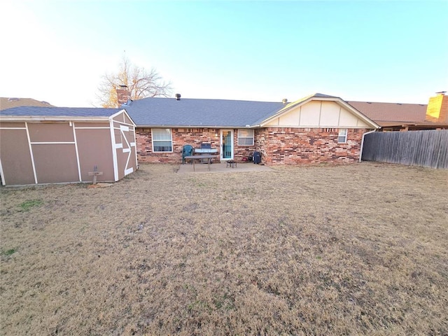 rear view of property featuring a lawn and a patio area