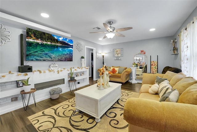 living room with ceiling fan and dark hardwood / wood-style floors