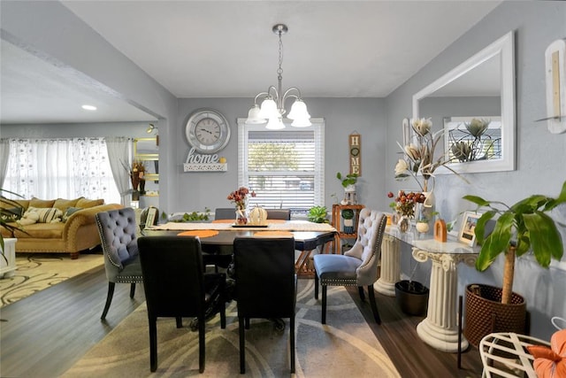 dining room featuring an inviting chandelier and dark hardwood / wood-style floors