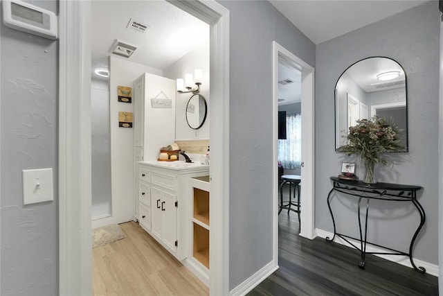 bathroom with vanity and hardwood / wood-style floors