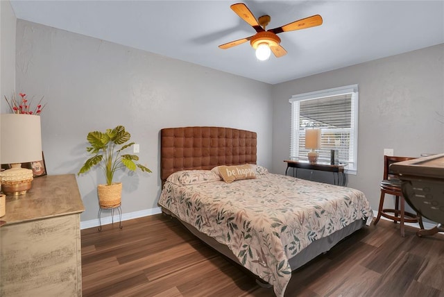 bedroom with dark hardwood / wood-style flooring and ceiling fan