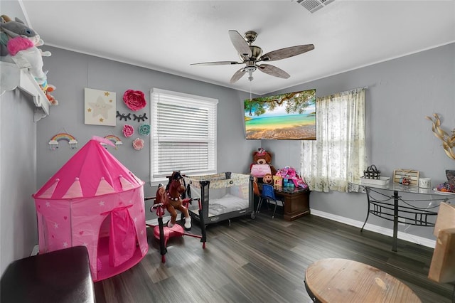 game room with ceiling fan and dark wood-type flooring