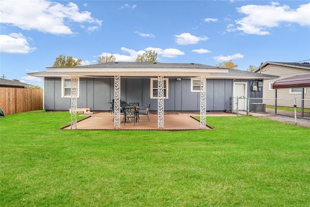 back of house featuring a patio and a yard