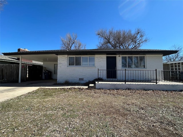 view of front of house featuring crawl space, driveway, fence, and an attached carport