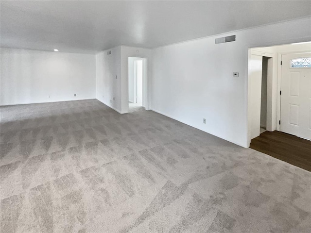 unfurnished living room featuring carpet floors