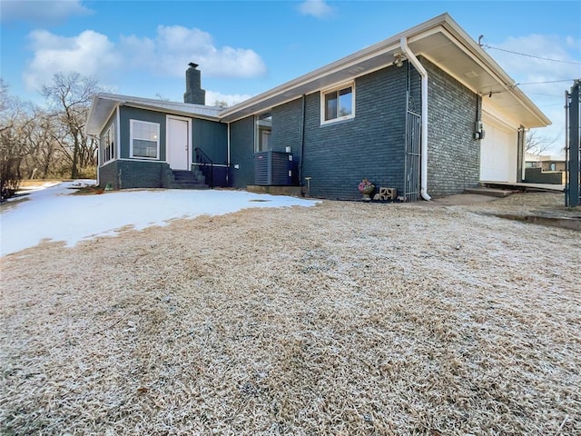 rear view of property featuring a garage