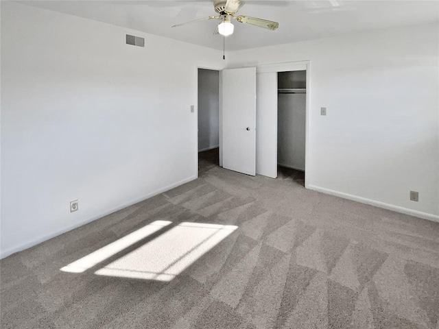 unfurnished bedroom featuring ceiling fan, a closet, and carpet flooring