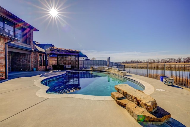 view of pool with a patio area and a water view