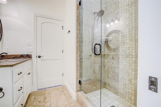 bathroom with vanity, tile patterned flooring, and an enclosed shower