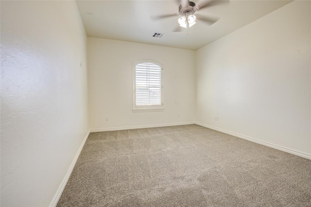 spare room featuring ceiling fan and light colored carpet