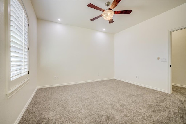 spare room featuring ceiling fan and carpet flooring