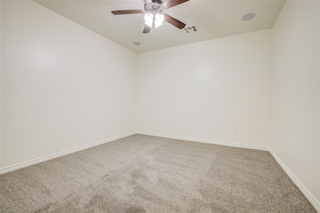 carpeted spare room featuring ceiling fan