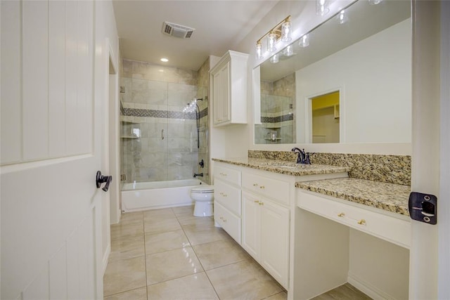 full bathroom featuring toilet, tile patterned floors, vanity, and shower / bath combination with glass door