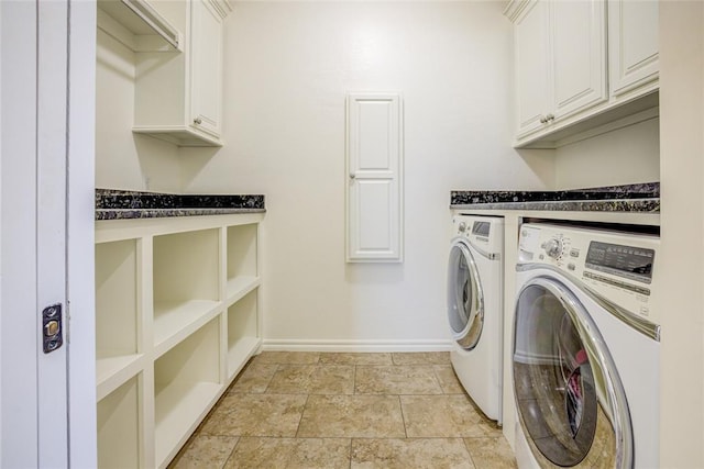 laundry room featuring independent washer and dryer and cabinets