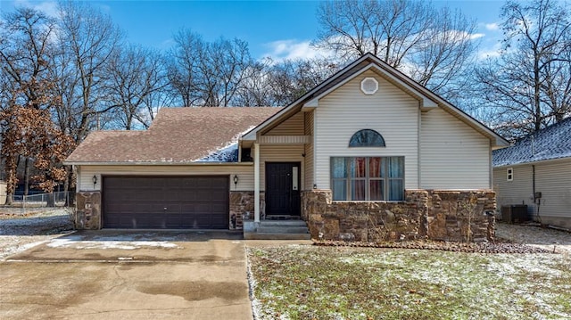 view of front of property with a garage and cooling unit