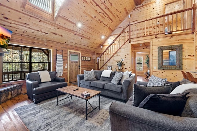 living room featuring wooden ceiling, hardwood / wood-style floors, high vaulted ceiling, and wood walls