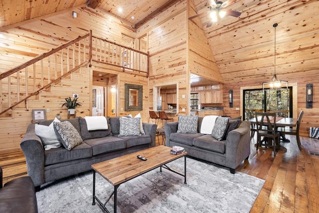 living room featuring wood ceiling, wooden walls, high vaulted ceiling, beam ceiling, and dark hardwood / wood-style floors